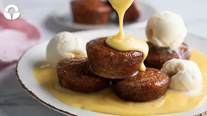 A white plate topped with donuts covered in icing
