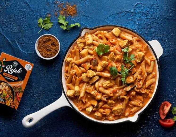 A pan of pasta with sauce and spices