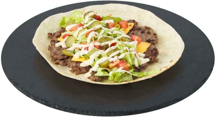 A tortilla filled with meat, lettuce and tomatoes
