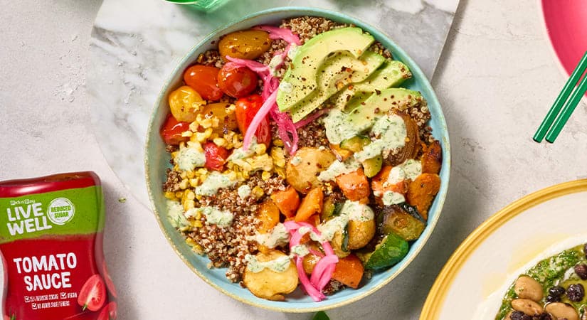 A bowl of food next to a plate of salad