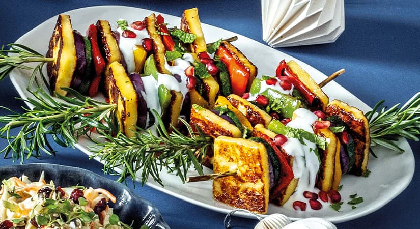A platter of grilled vegetables with dressing