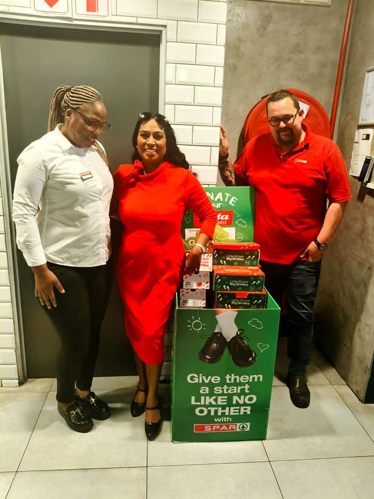 A group of people standing next to a green box