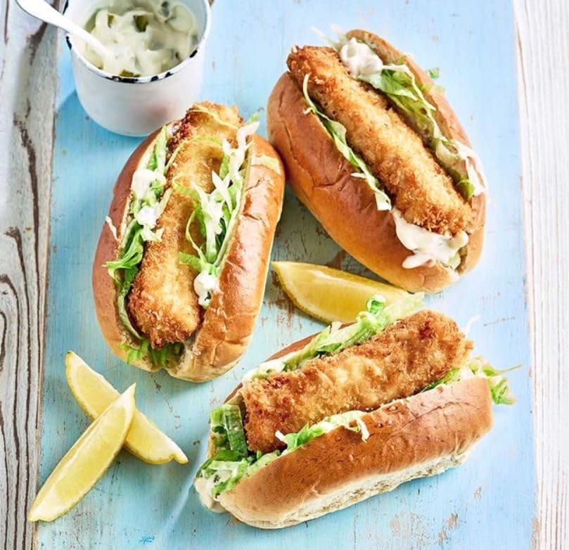 A couple of sandwiches sitting on top of a blue cutting board