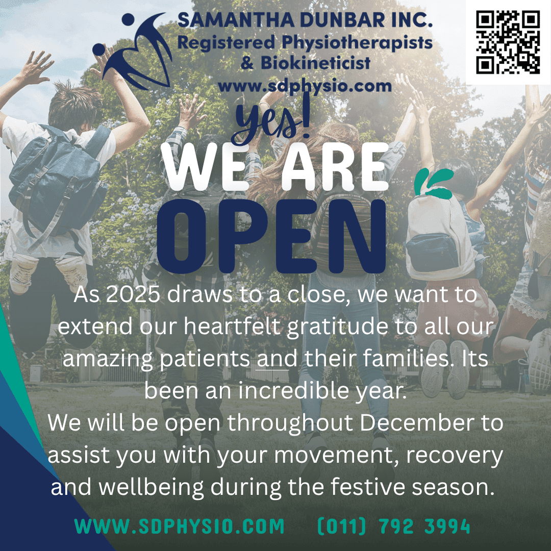 A group of people standing in a field with their arms in the air